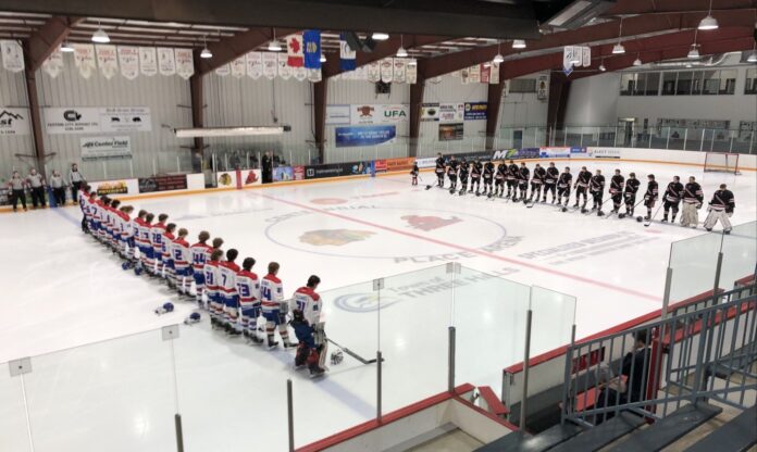 Moment of silence observed by Mountain View Colts and Three Hills Thrashers in memory of Bryce Quaschnick, Assistant Coach and Goaltending Coach for the Colts on February 10, 2025. (Galen Hartviksen, mymountainviewnow.com staff)