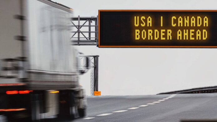 A semi-trailer approaches the Canada-U.S. border in this photo illustration. (Photo courtesy of Economic Development Canada)